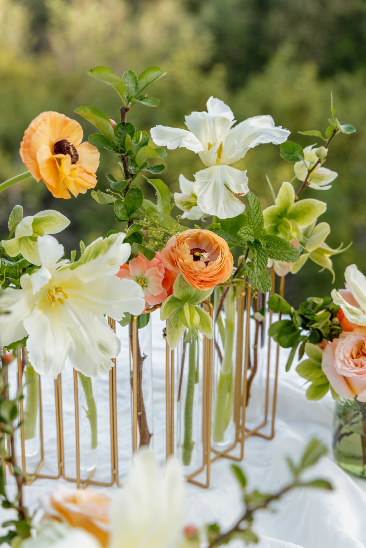 Peach and white flowers displayed in individual vases